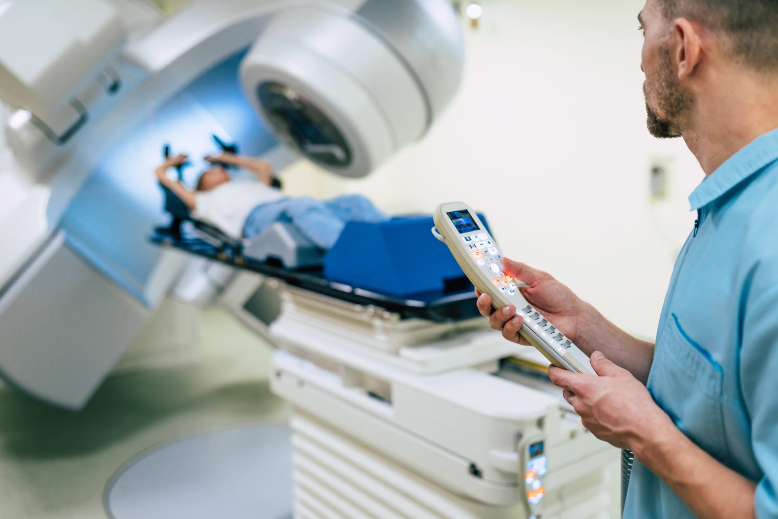 Cancer treatment in a modern medical private clinic or hospital with a linear accelerator. Professional doctors team working while the woman is undergoing radiation therapy for cancer